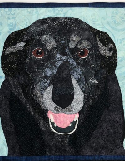 fabric wall hanging of black dog