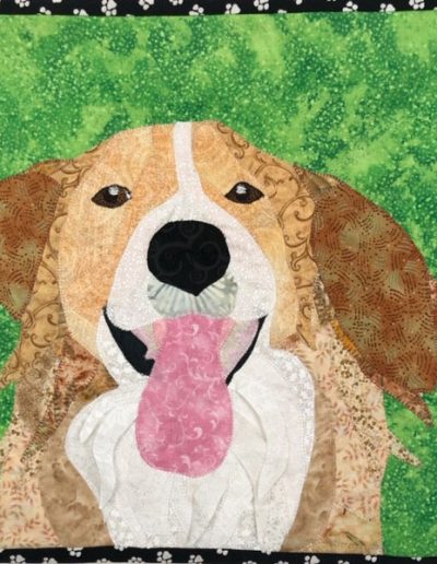 memorial pet portrait: brown dog with green background on fabric wall hanging