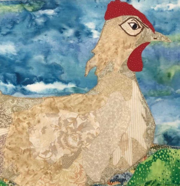 closeup of fabric art piece of white chicken and stormy background