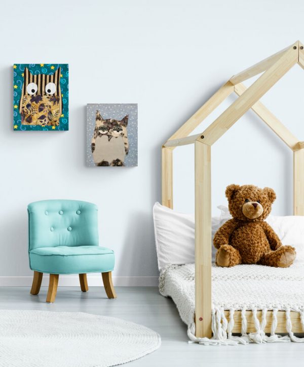Two owl wall hangings in child's room with teddy bear