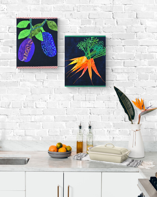 canvas eggplant art and canvas carrot art on the wall of a kitchen