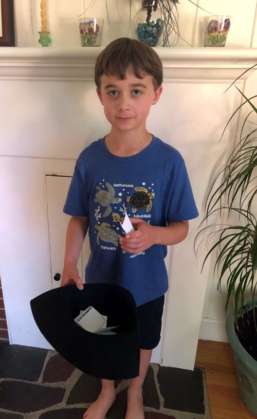 Boy picking name out of hat