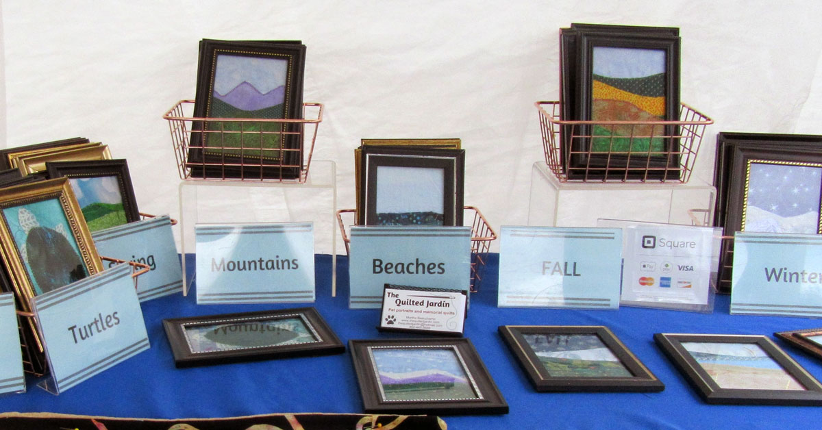 craft fair display of small framed wall hangings