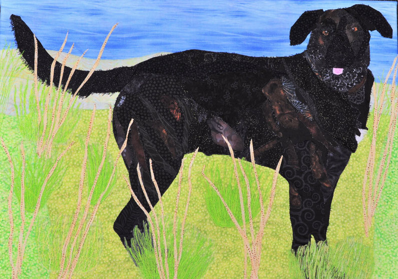 fabric pet portrait of black dog in a field of grass