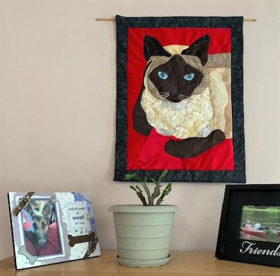 fabric pet portrait of cat hanging on wall
