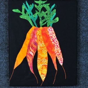 Bunch of orange fabric carrots with green tops on black background , mounted on canvas