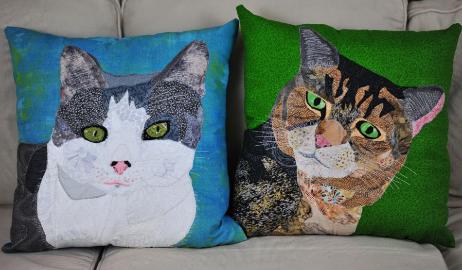 two fabric pillows of cat faces