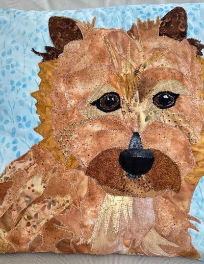 A pet portait pillow of a tan dog.