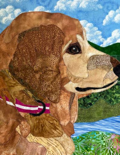 The fabric picture is of the chest and face of golden setter outside with the Green Mountains and a creekn the background. It was a pet portrait memorial.